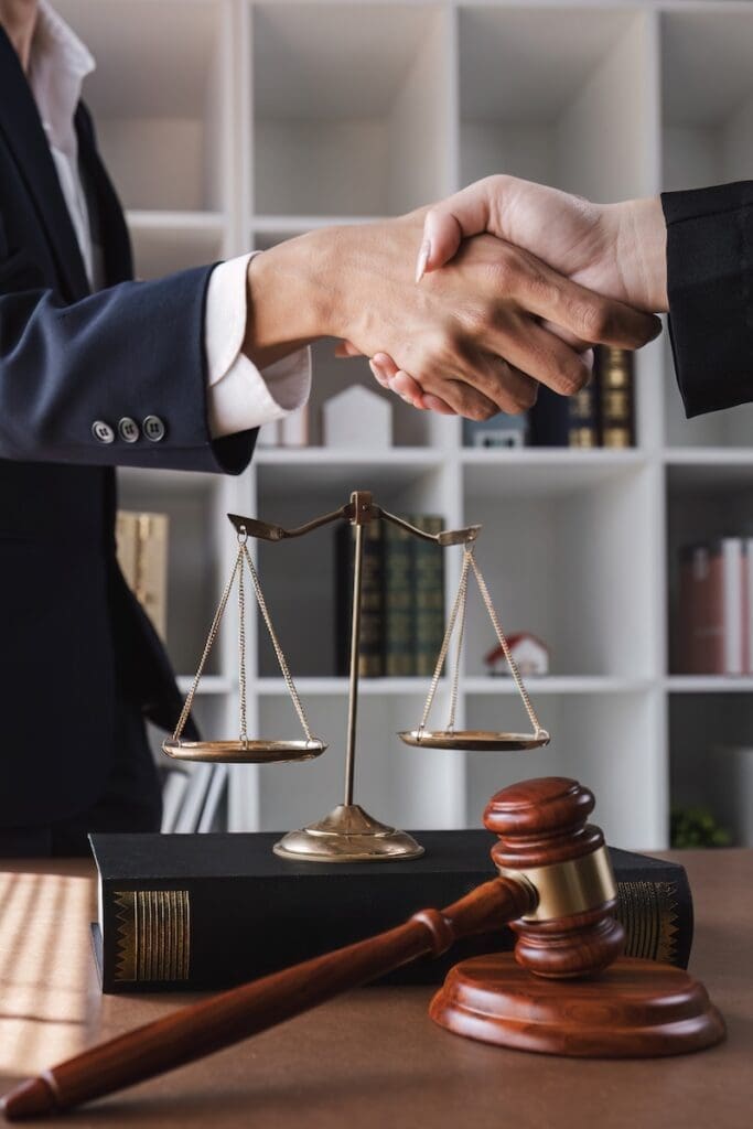 legal advice A lawyer shakes hands with a client after a successful consultation..